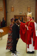 A young man from SJF is Confirmed by Bishop Parker.